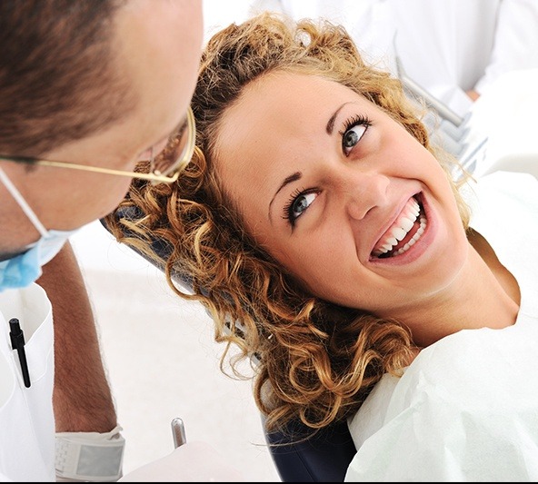 Laughing woman in dental chair