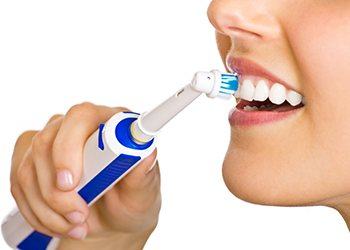 Closeup of patient brushing teeth