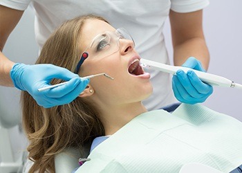 Woman receiving oral cancer screening