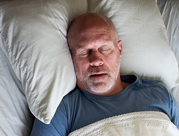 Man sleeping soundly in bed