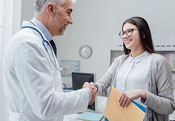 Patient shaking hands with dentist