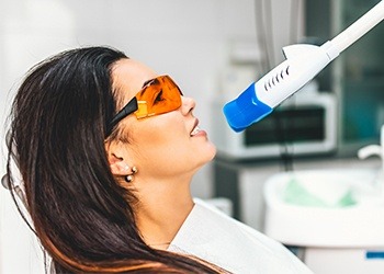 Woman receiving teeth whitening treatment